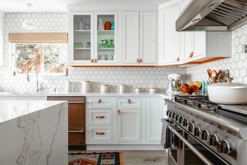 Modern kitchen remodel completed by Austin Painting and Cabinets in Westlake Hills, featuring white shaker cabinets and quartz countertops